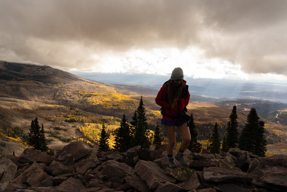 Explore autumn's beauty with a hiker enjoying stunning views of the La Sal Mountains in Utah.