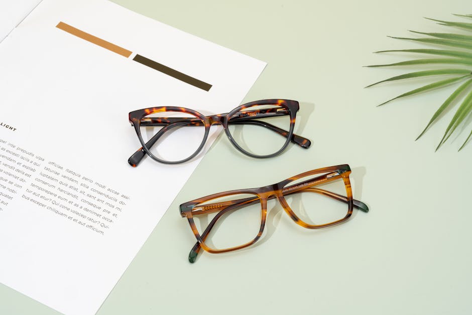 Trendy tortoise shell glasses displayed on a minimal layout with palm leaf accent.