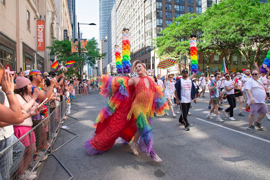 A vibrant Pride parade in Toronto with diverse participants celebrating LGBTQ+ rights.