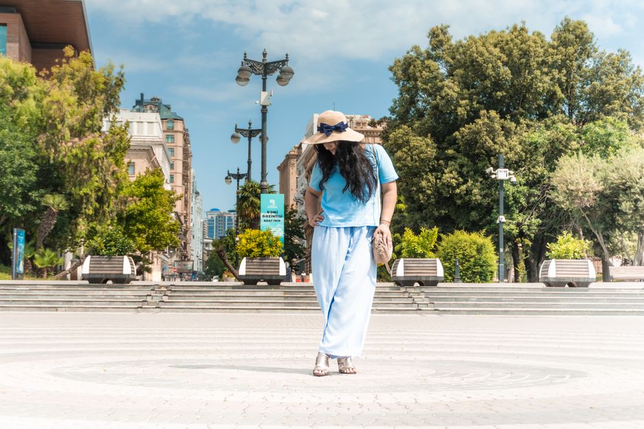 Caucasian woman enjoys a peaceful walk in Baku Boulevard, Azerbaijan.
