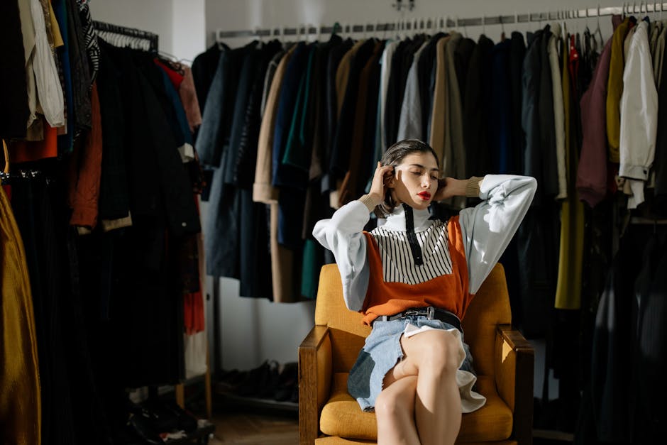 A stylish female model sits in a retro wardrobe setup.